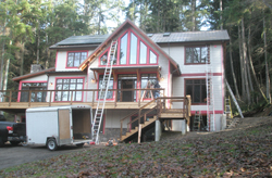 View of the house, with its trim painted with pink primer